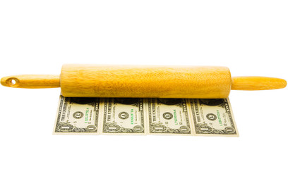 Close-up of rolling pin on currency