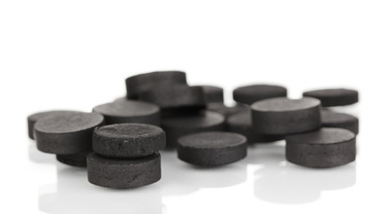 activated carbon in tablets isolated on white