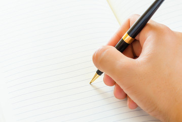 male hand signing a contract.