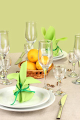 Table setting in green and yellow tones on color  background