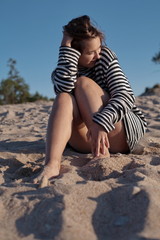 Fototapeta na wymiar girl on a sandy shore
