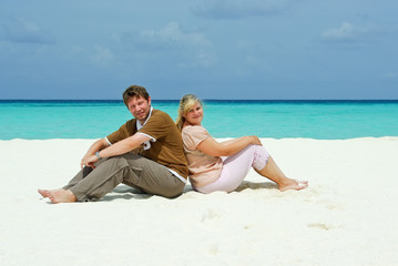 Young couple on caribbean beach on honeymoon