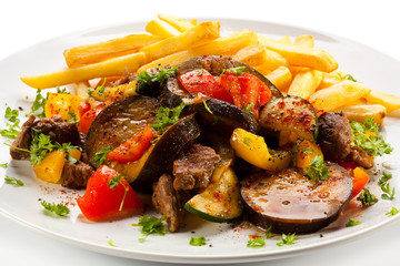 Roasted meat, French fries and vegetables