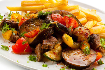 Roasted meat, French fries and vegetables