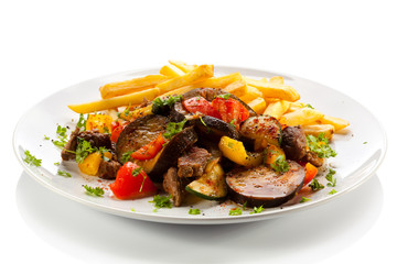 Roasted meat, French fries and vegetables