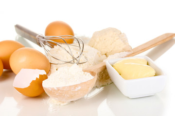 Eggs, flour and butter isolated on white