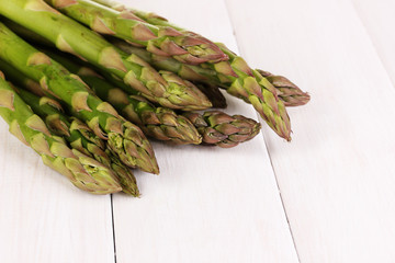 Fresh asparagus on white wooden table background