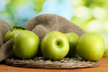 Ripe green apples with leaves