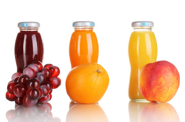 Delicious grapes, orange and apple juice in glass bottle and