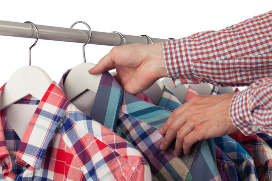 Man in checked shirt choosing another checked shirt