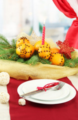 beautiful christmas table setting with tangerines and fir tree,
