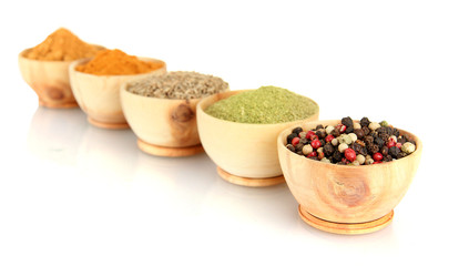 wooden bowls with spices isolated on white