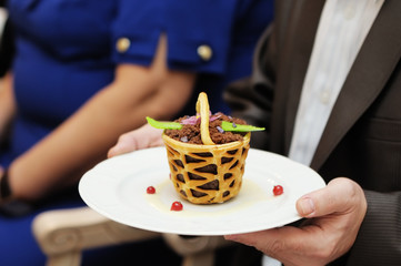 Man holding plate with tasty dessert