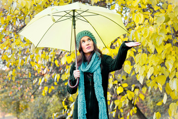 beautiful young girl under yellow umbrella