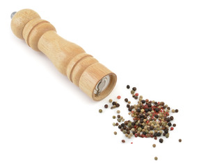Pepper mill with black pepper close-up isolated on white