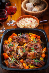 Roasted pork belly on vegetables with sauerkraut