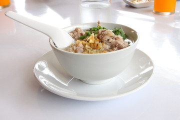 Pork congee spoon and fried garlic on morning table.