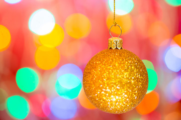 Golden christmas ball on bokeh background