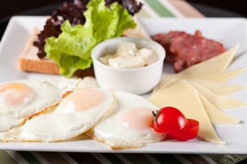 Breakfast fried eggs on a white plate