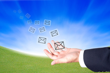 Business hand hold a message icons to sending out