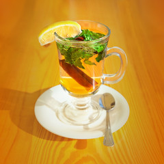 Cinnamon, mint and honey tea on a wooden table 