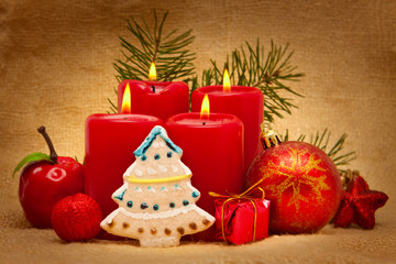 Four red candles with Christmas balls. 