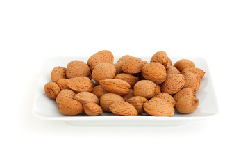 Almond on a plate isolated on white background