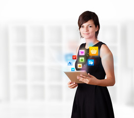 Young woman looking at modern tablet with colourful icons