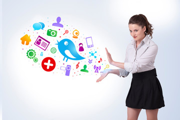 Young business woman presenting colourful social icons