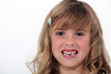 Little girl baring her teeth
