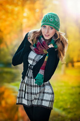 Young attractive fashion woman in the autumn park