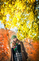 Young attractive fashion woman in the autumn park