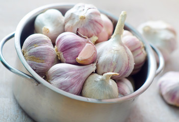 garlic in metal bowl on the table
