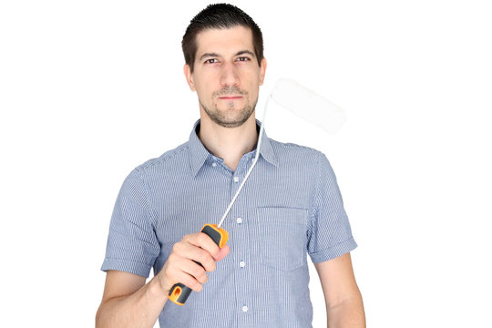 A portrait of attractive young man holding a paint brush