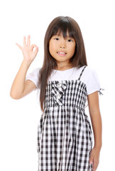 Smiling little asian girl with okay gesture