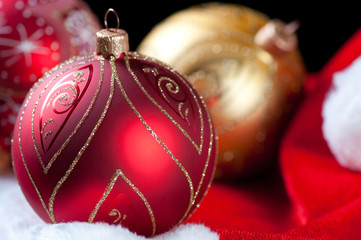 Bright Christmas baubles on Santa hat, studio shot