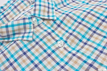 Woman's checked shirt close up.