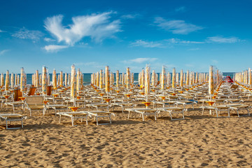 withdrawn umbrellas and sunlongers on the sandy beach