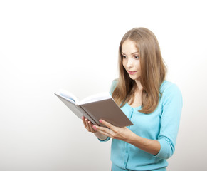 Young woman reading a book, isolated