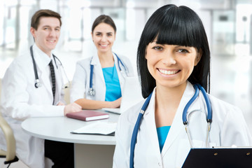 Female doctor standing in frount of his team