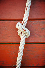 Rope with metal ring on wooden beam