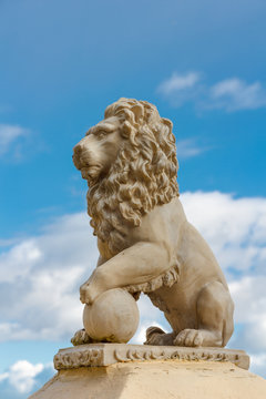 Statue of a lion against a blue sky