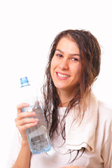 Attractive young brunette woman with bottle of water