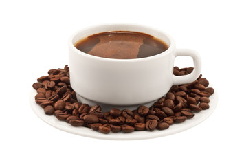 White cup of coffee with beans on a plate