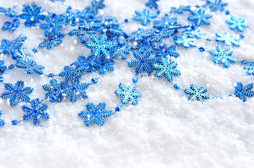 Christmas blue snowflakes of decoration on snow