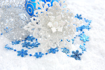 Christmas blue and silver decorations on snow