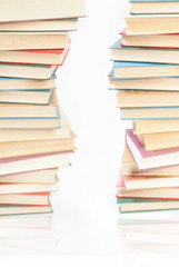 Two towers of books on white