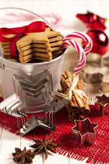 Gingerbread cookies and candy canes in a decorative bucket