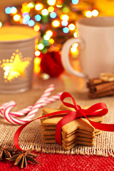 Gingerbread cookies and a cup of tea in front of christmas tree