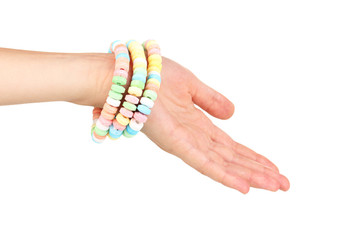 Color candies on hand isolated on white